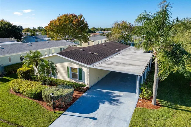 an aerial view of a house with garden space and street view