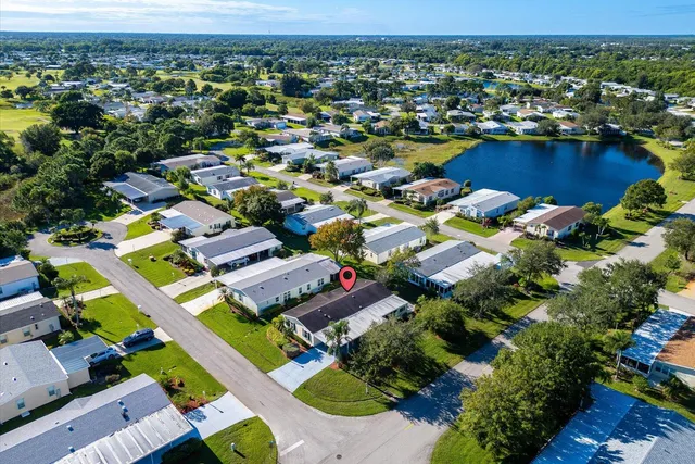 an aerial view of residential houses with outdoor space and ocean view