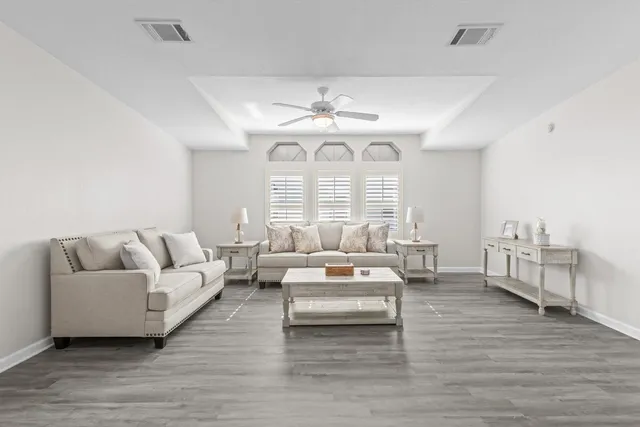 a living room with furniture and a chandelier