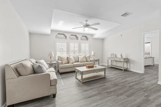 a living room with furniture and wooden floor