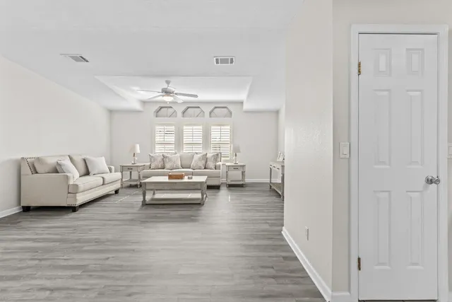 a dining room with furniture wooden floor a rug and a painting