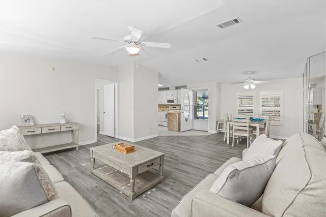 a view of a dining room with furniture and wooden floor