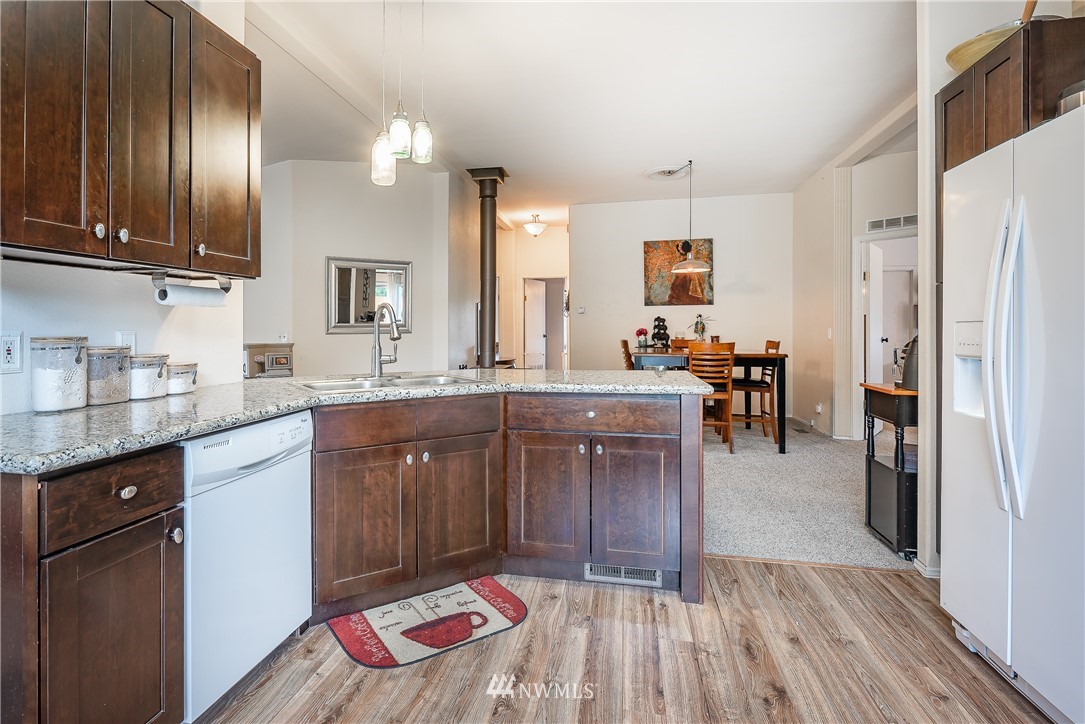 4165 Deming Road Everson, WA 98247 - Photo 11 of 31 a kitchen with granite countertop a sink stove and refrigerator