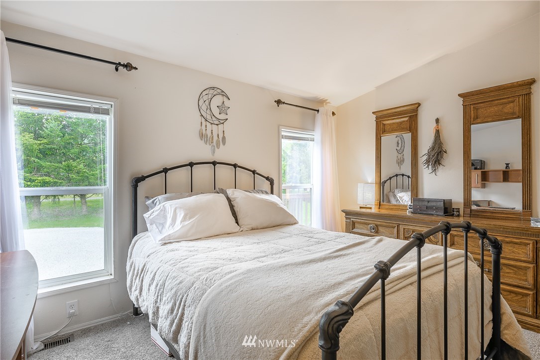 4165 Deming Road Everson, WA 98247 - Photo 17 of 31 a bedroom with a large bed and a large window