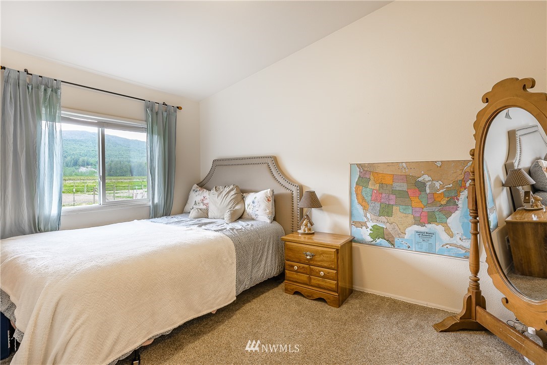 4165 Deming Road Everson, WA 98247 - Photo 19 of 31 a bedroom with a bed and a painting on the wall