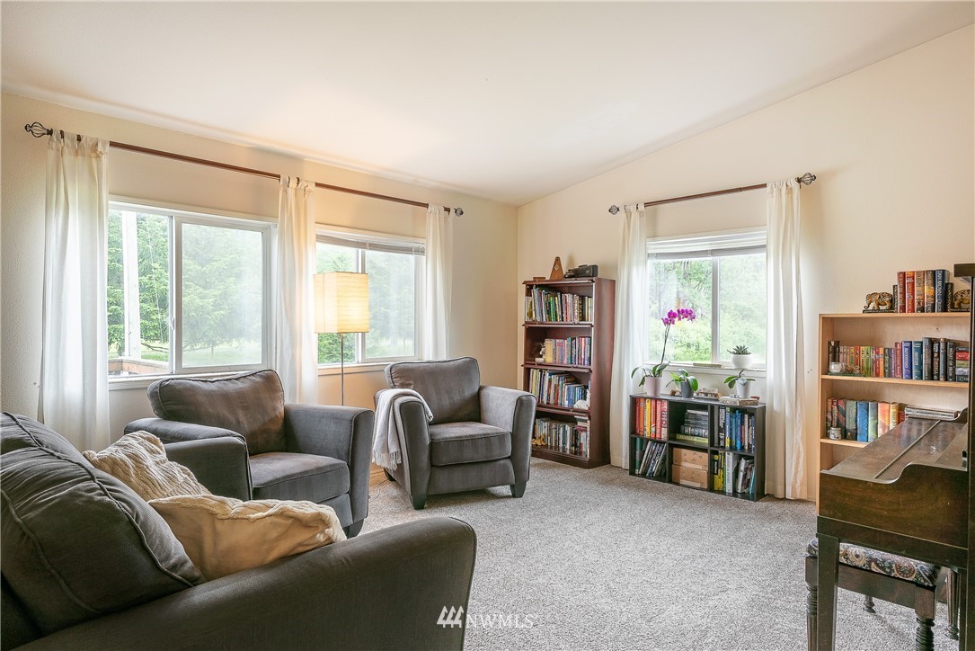 4165 Deming Road Everson, WA 98247 - Photo 8 of 31 a living room with furniture and a book shelf