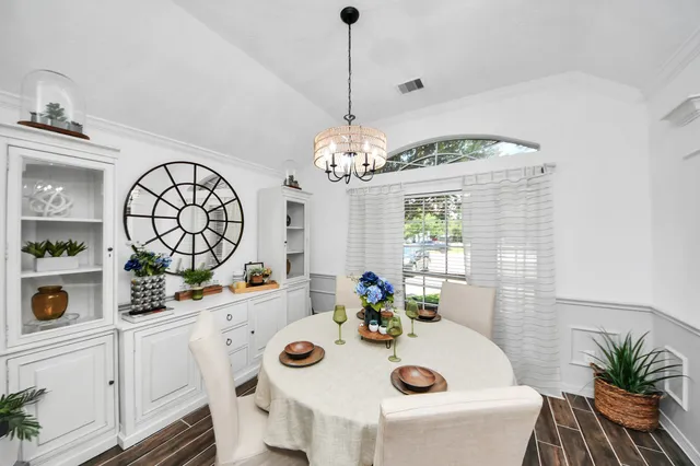 a view of a dining room with furniture and chandelier