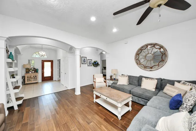 a living room with furniture fireplace and flat screen tv