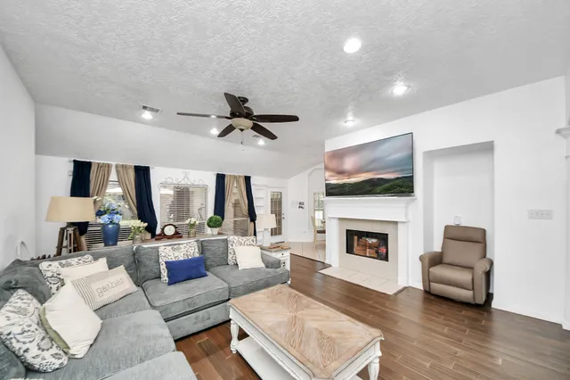 a living room with furniture and a wooden floor