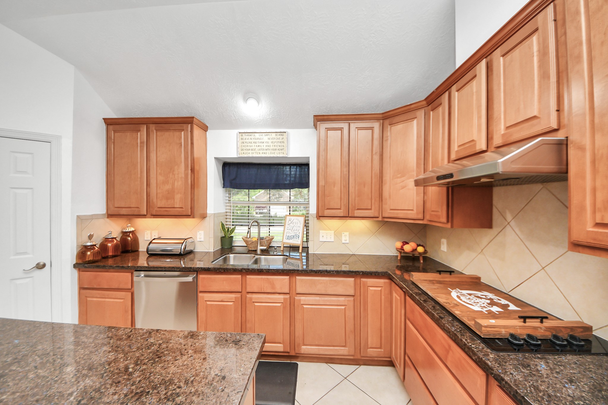 5231 South Fm 565 Rd Cove Cove, TX 77523 - Photo 28 of 50 a kitchen with stainless steel appliances granite countertop a sink stove and cabinets