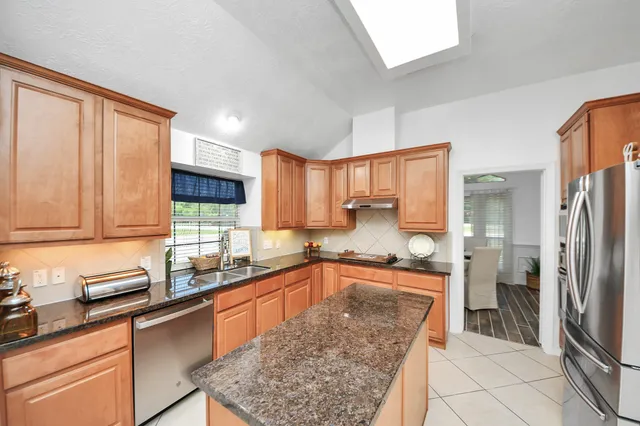 a kitchen with granite countertop a sink and a counter top space