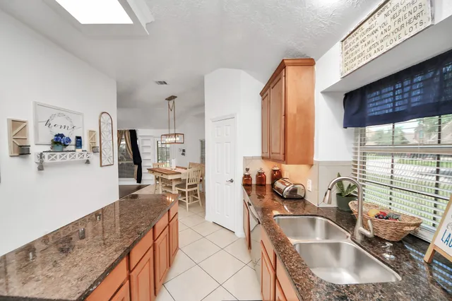 a living room with couches a coffee table and a large window with outer view