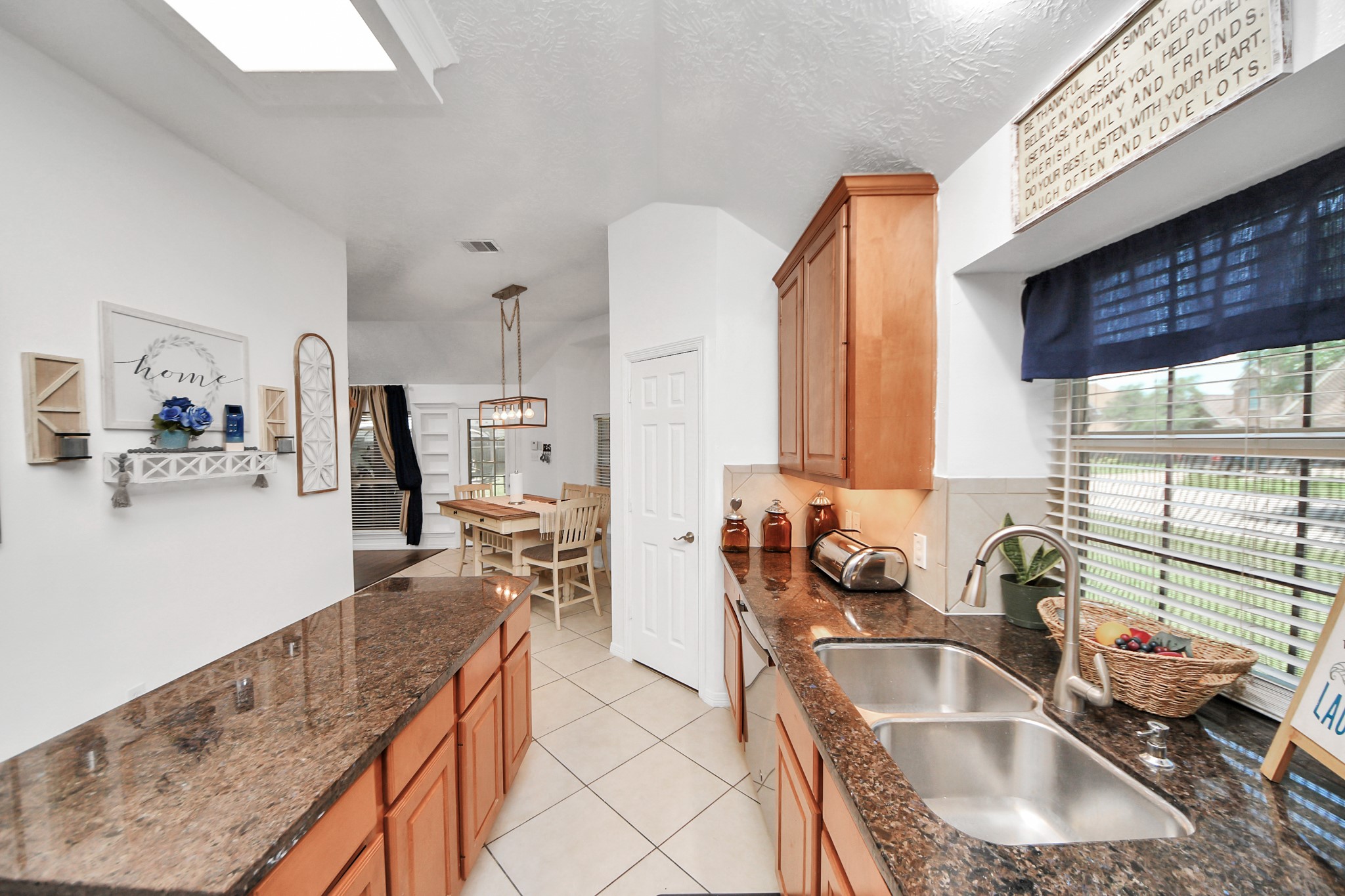 5231 South Fm 565 Rd Cove Cove, TX 77523 - Photo 31 of 50 a kitchen with granite countertop a sink and a counter top space