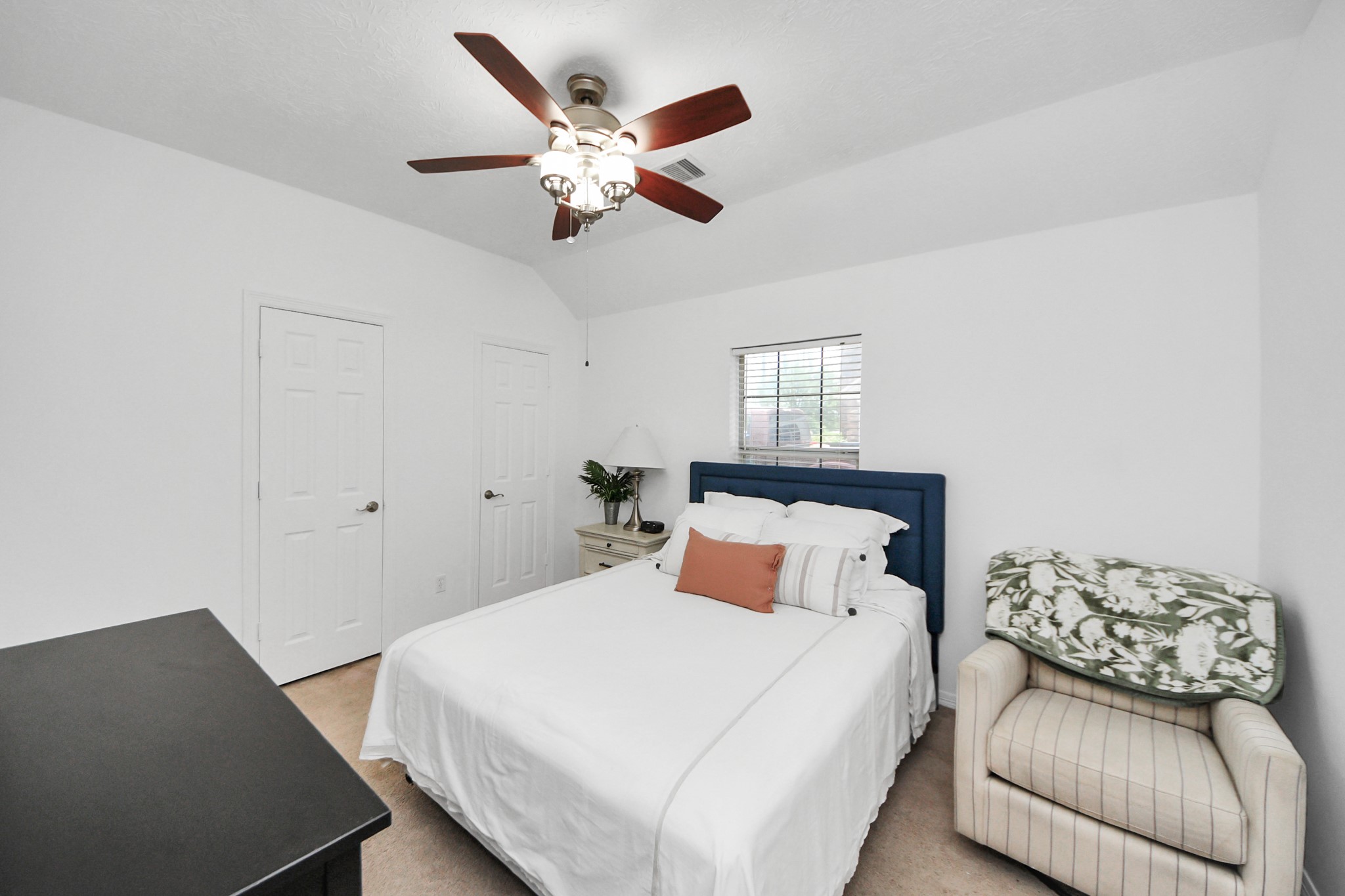 5231 South Fm 565 Rd Cove Cove, TX 77523 - Photo 35 of 50 a bedroom with a large bed and a chandelier