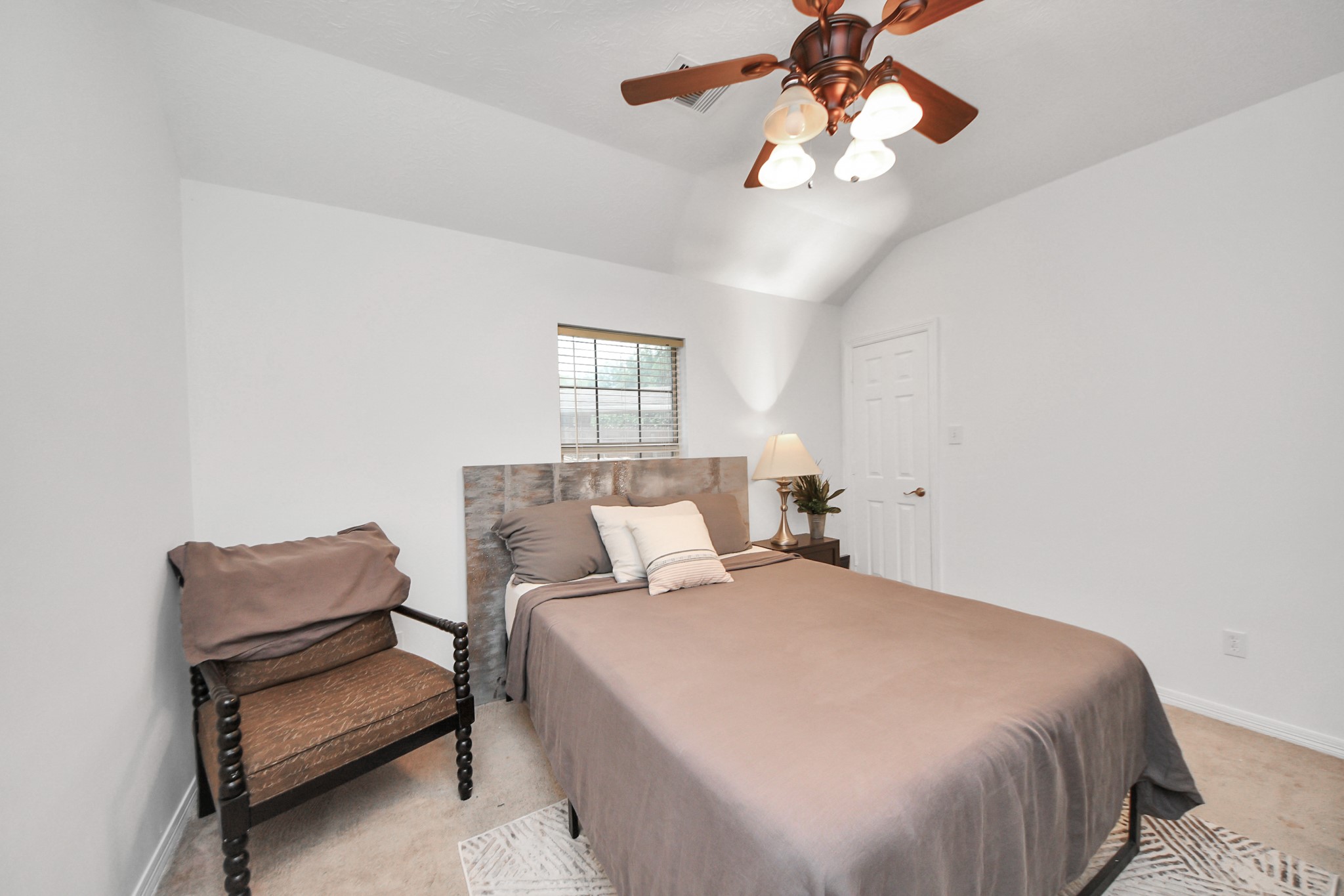 5231 South Fm 565 Rd Cove Cove, TX 77523 - Photo 37 of 50 a bedroom with a bed and a chandelier