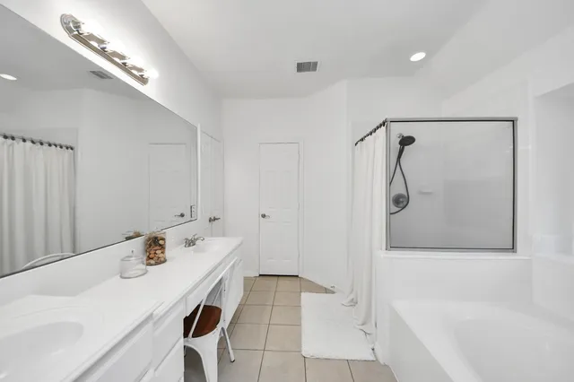 a bathroom with a tub and a shower