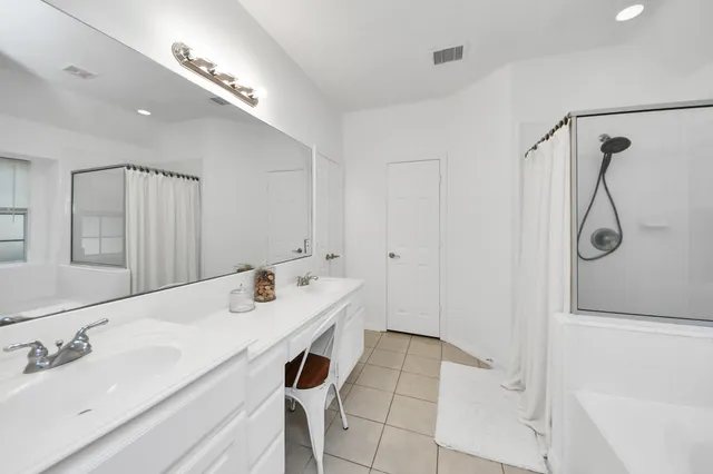 a bathroom with a tub sink and mirror