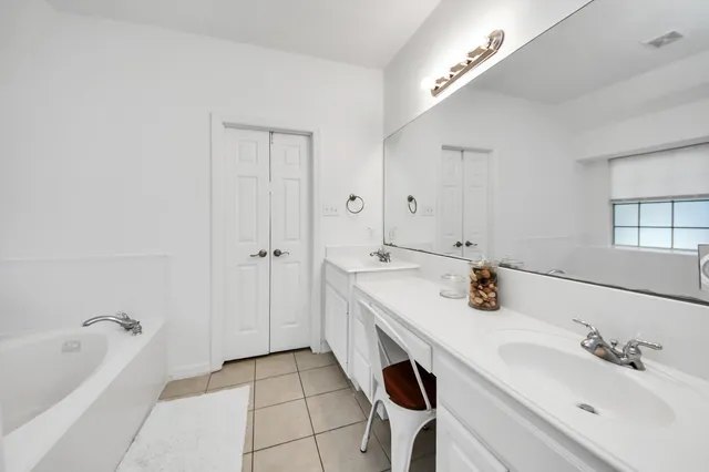 a view of a chair and table in backyard of the house