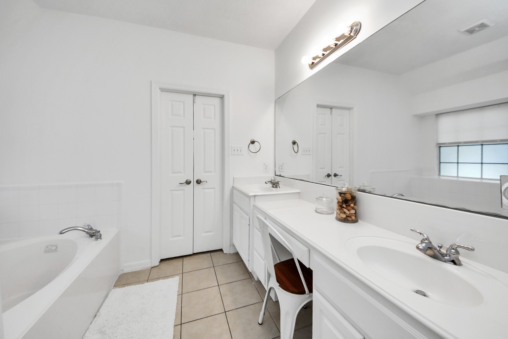 5231 South Fm 565 Rd Cove Cove, TX 77523 - Photo 45 of 50 a bathroom with a tub sink and mirror