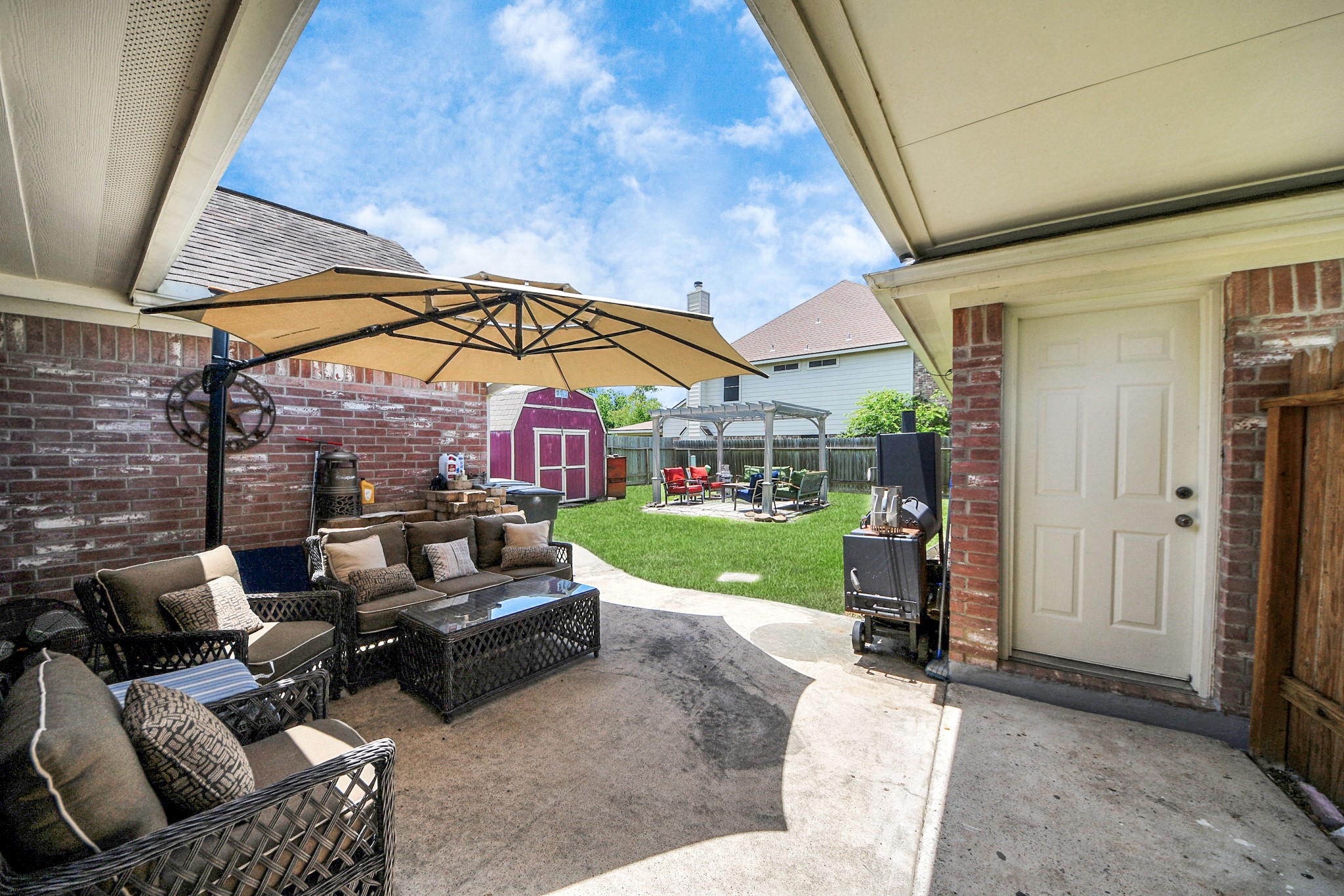 5231 South Fm 565 Rd Cove Cove, TX 77523 - Photo 46 of 50 a patio with patio a table and chairs under an umbrella