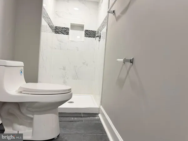 a bathroom with a toilet a sink and a shower