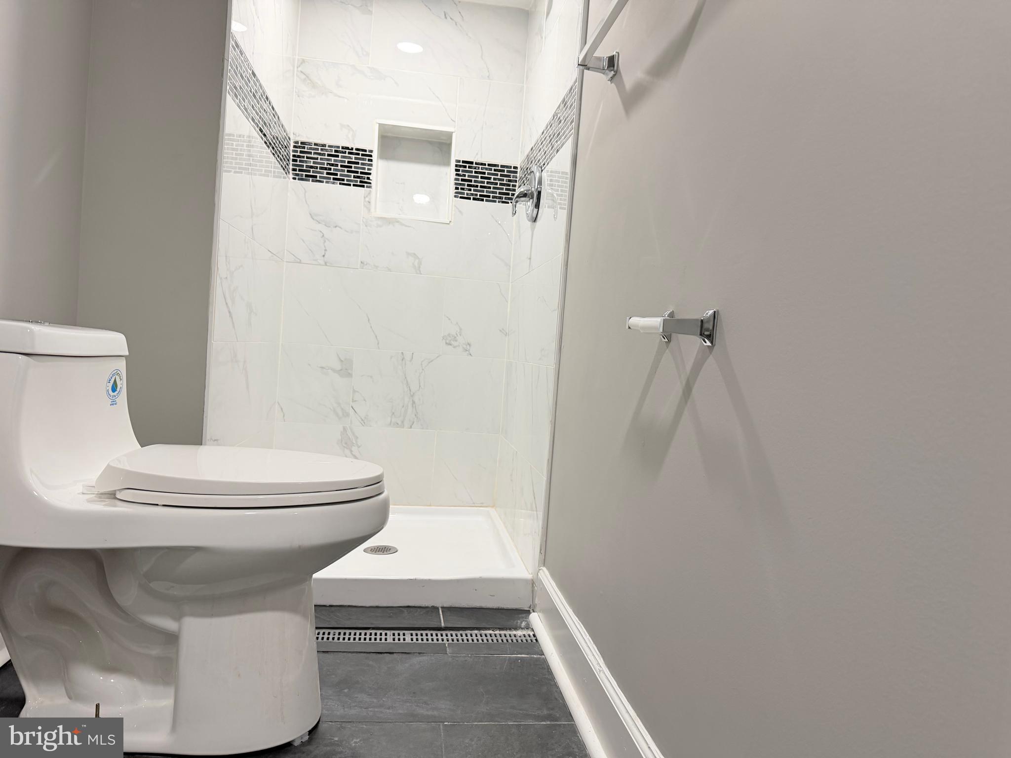 5115 Pembridge Avenue Baltimore, MD 21215 - Photo 17 of 29 a bathroom with a toilet a sink and a shower