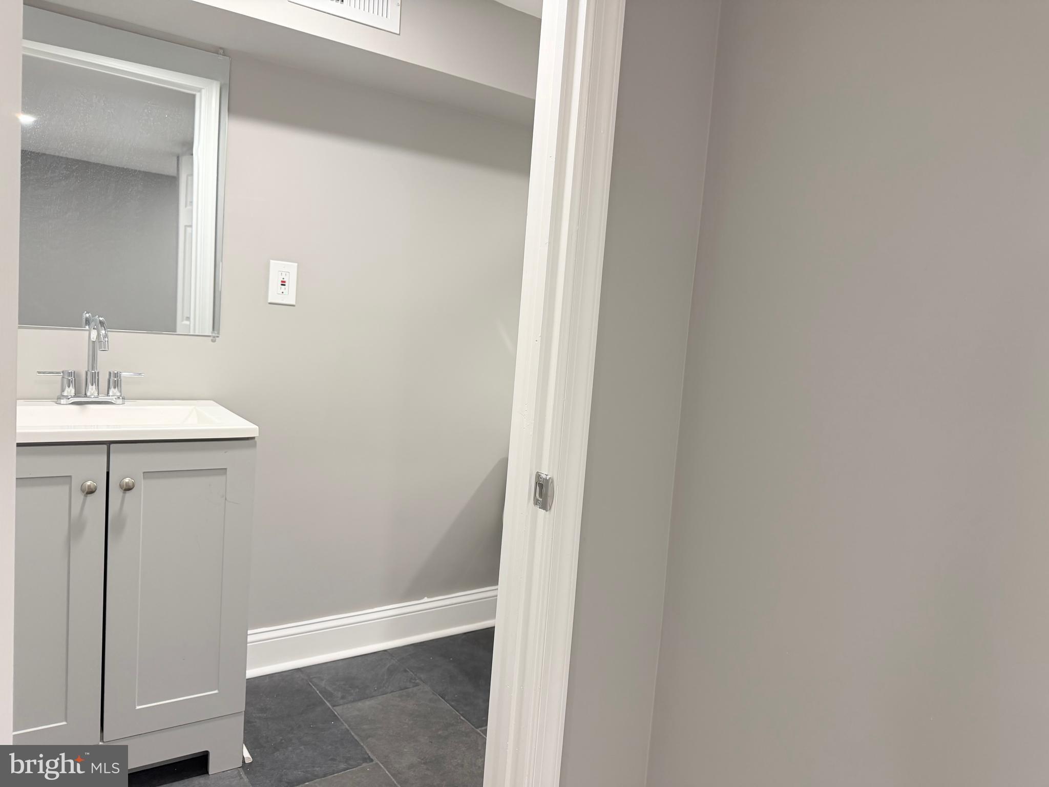 5115 Pembridge Avenue Baltimore, MD 21215 - Photo 18 of 29 a bathroom with a sink and a mirror