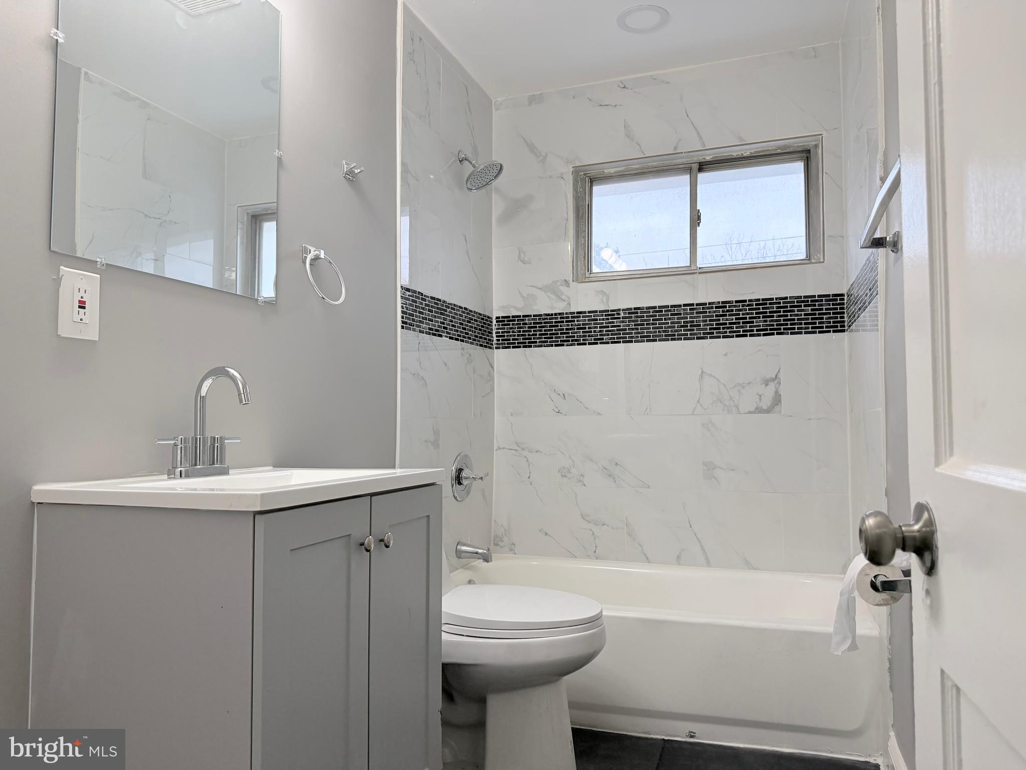 5115 Pembridge Avenue Baltimore, MD 21215 - Photo 24 of 29 a bathroom with a sink a toilet and shower
