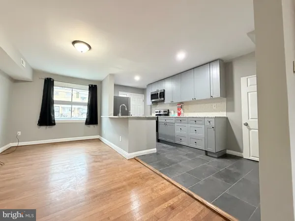 a view of a kitchen with a sink and a window