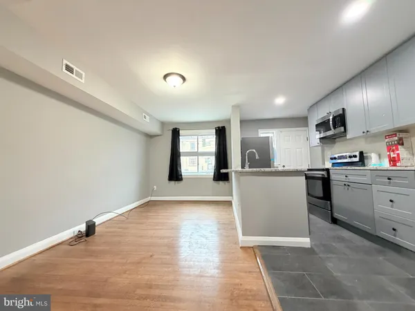 a view of kitchen with sink and cabinets