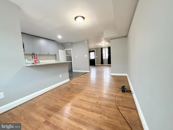 a view of a kitchen with kitchen island a sink wooden floor and window