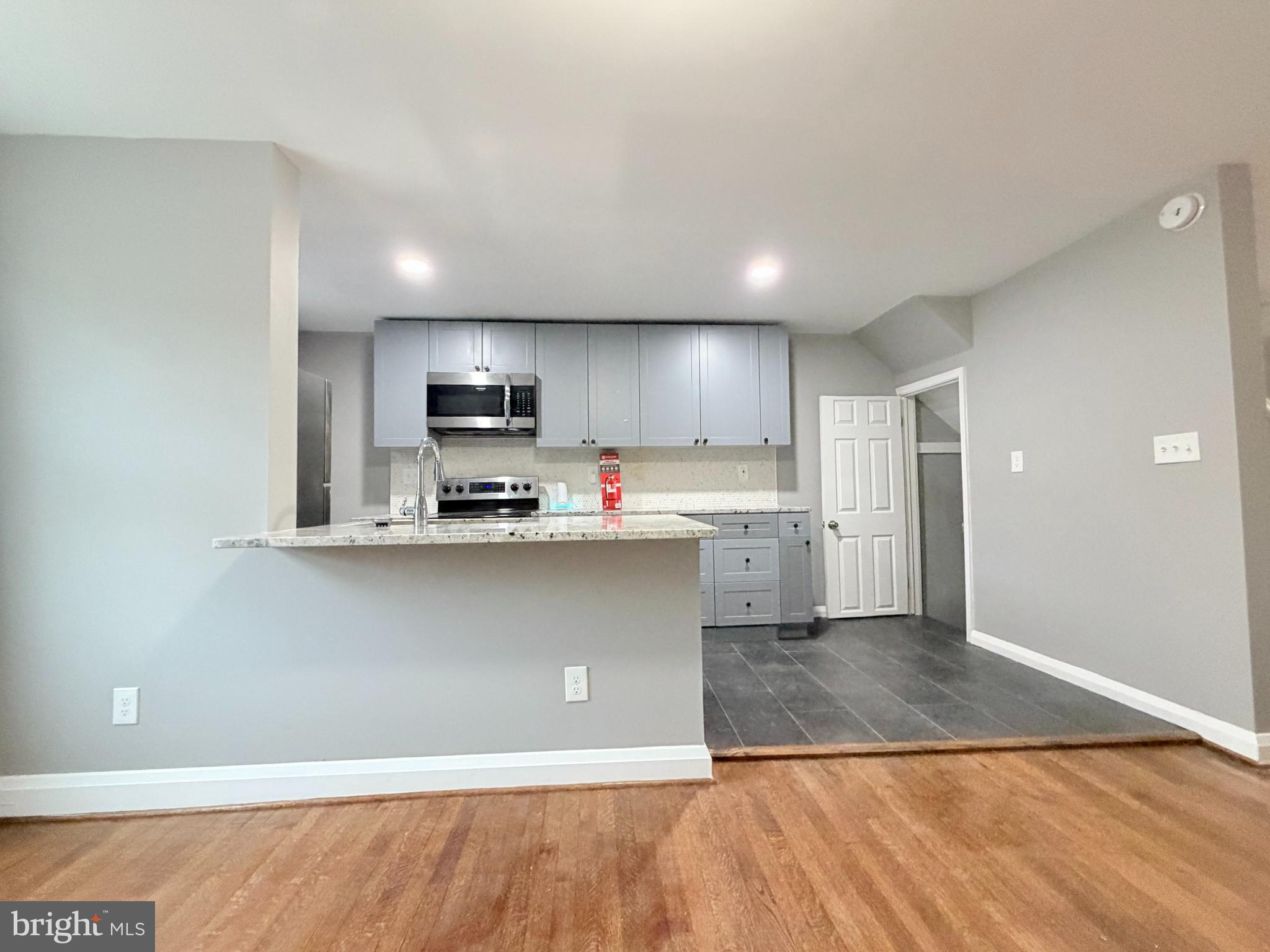 5115 Pembridge Avenue Baltimore, MD 21215 - Photo 8 of 29 a kitchen with stainless steel appliances granite countertop a refrigerator a stove and a sink