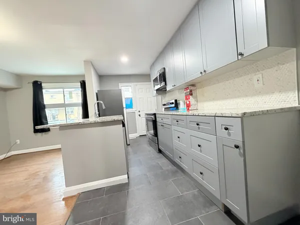 a kitchen with cabinets and window