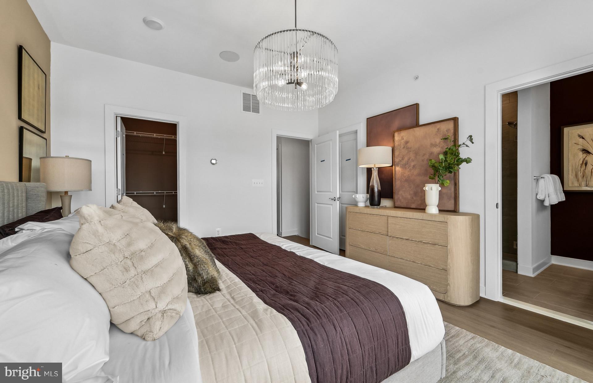 702 Shellbark Lane Laurel, MD 20724 - Photo 14 of 61 a bedroom with a large bed and a chandelier