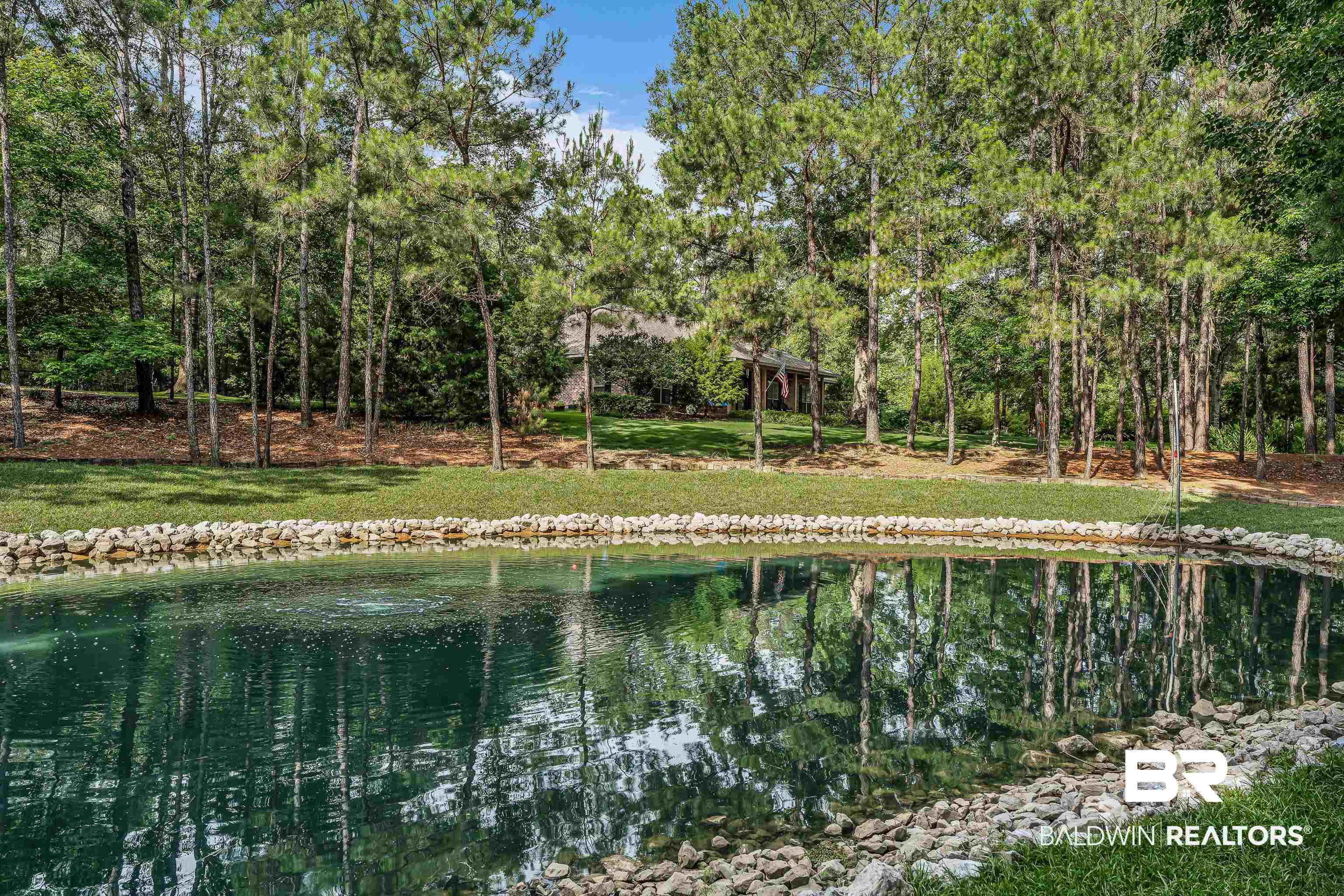 7014 Blakeley Road Daphne, AL 36527 - Photo 11 of 45 Tranquil water feature with a rock-lined perimeter