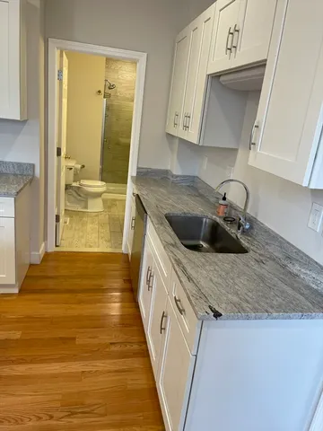 a kitchen with a sink and wooden cabinets