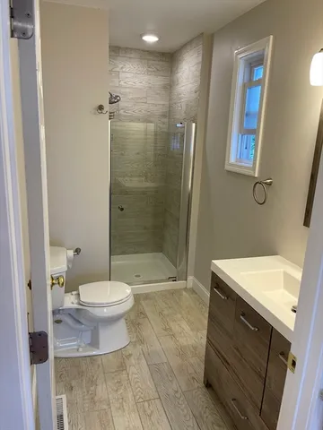 a bathroom with a sink toilet and shower