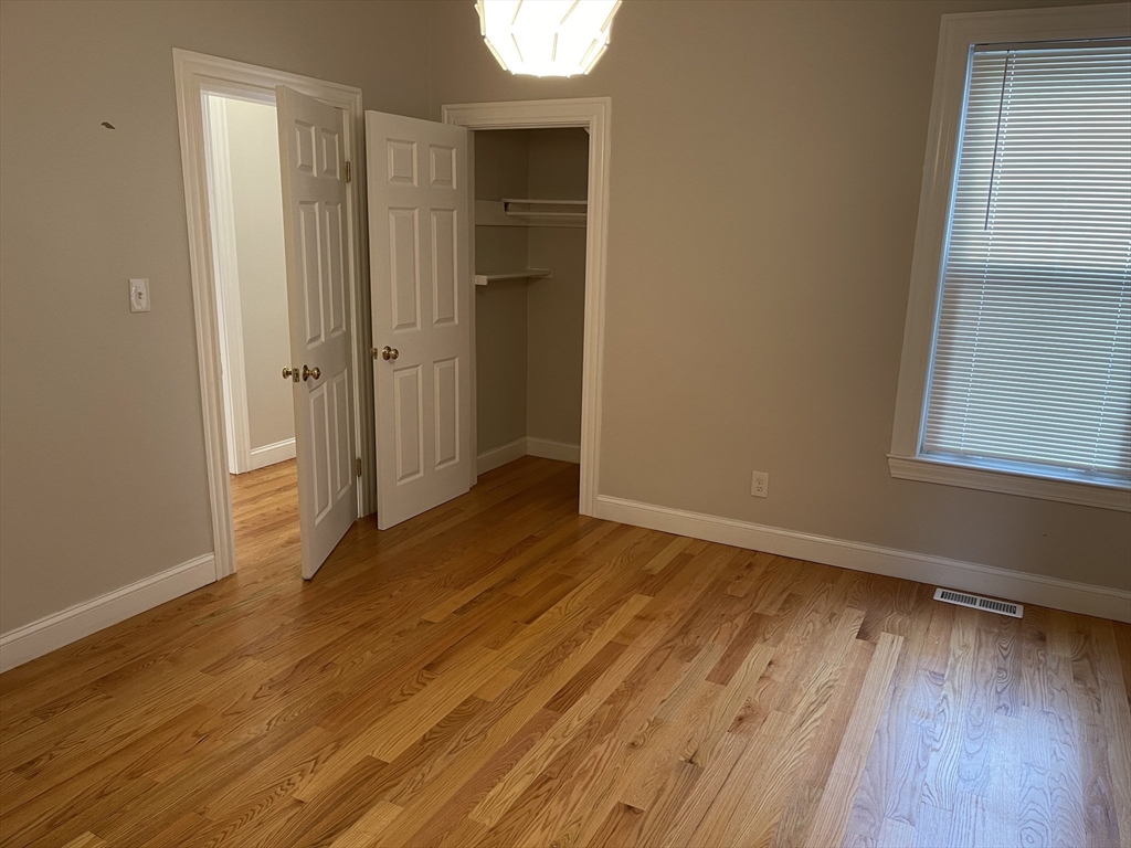79 Newton Street, Unit 79 Somerville, MA 02143 - Photo 10 of 24 a view of a room with wooden floor and a window