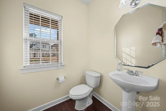 a bathroom with a sink toilet and a mirror