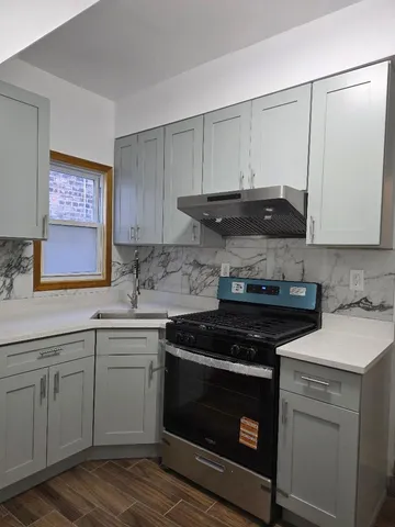 a kitchen with a sink stove and cabinets