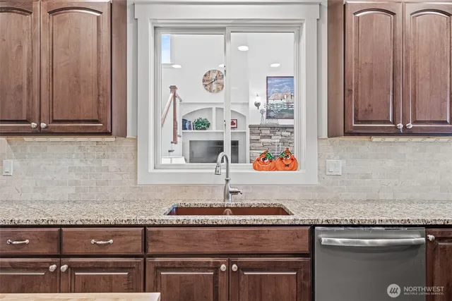 a kitchen with granite countertop a sink and a stove