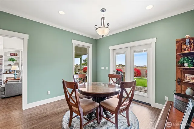 a view of a dining room with furniture wooden floor and a chandelier