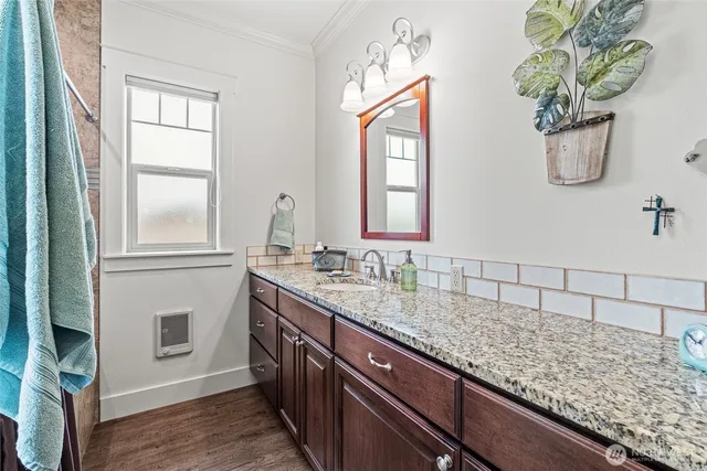 a bathroom with a granite countertop sink a mirror and a window