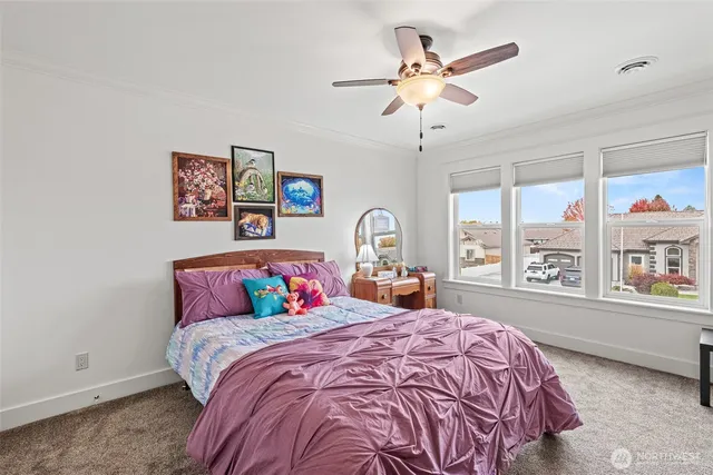 a bedroom with a large bed and a large window