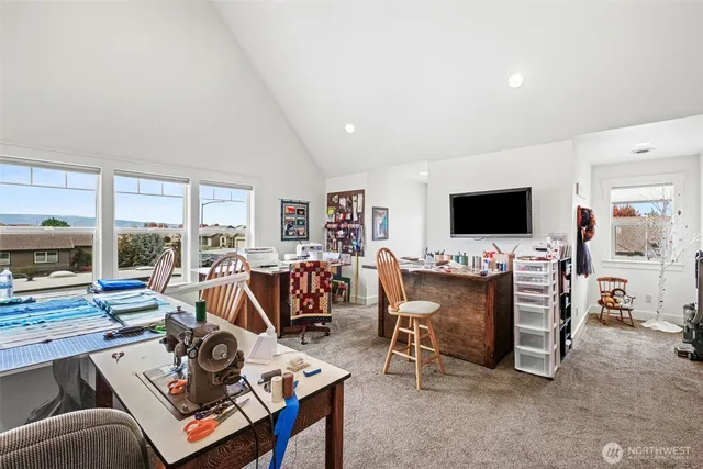 a living room with furniture a flat screen tv and a floor to ceiling window