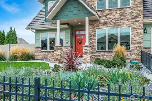a front view of a house with garden