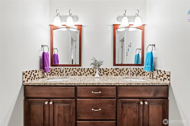 a bathroom with a sink vanity and a mirror