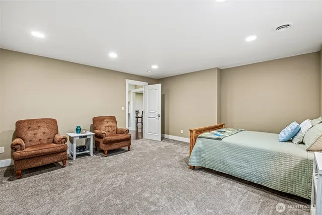 a bedroom with bed and a couch