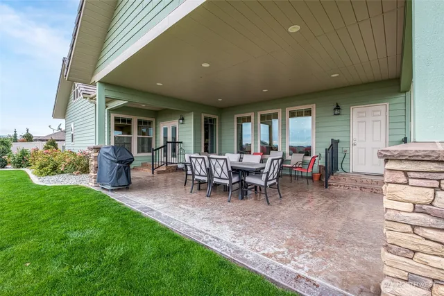a view of a patio with dining table and chairs