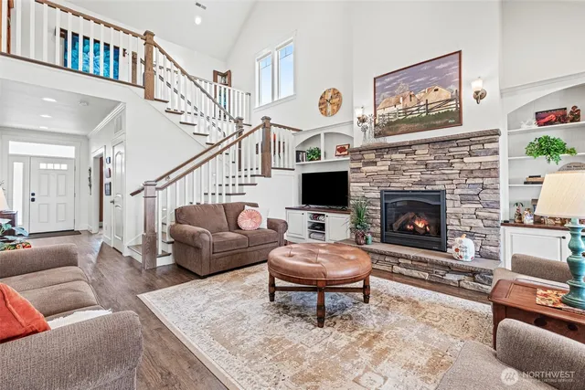 a living room with furniture a flat screen tv and a fireplace